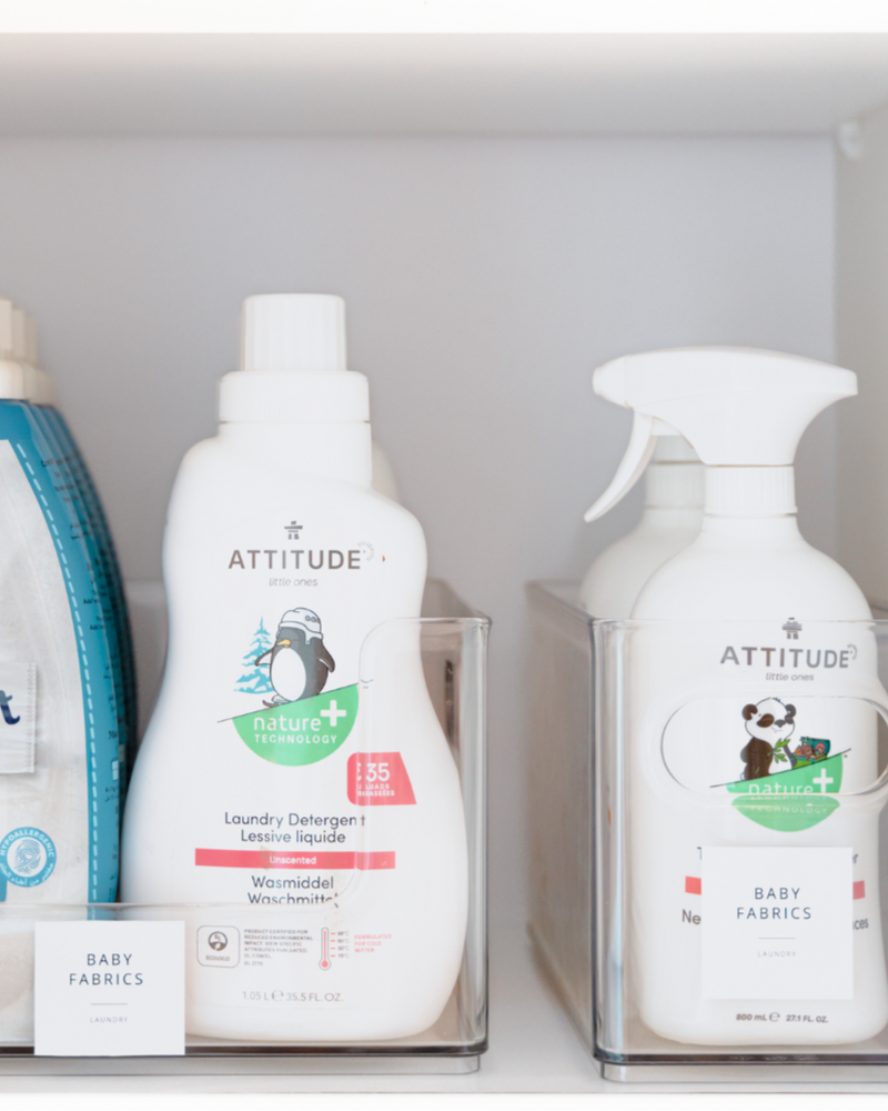 Shelving unit with cleaning products including Attitude and Omo.